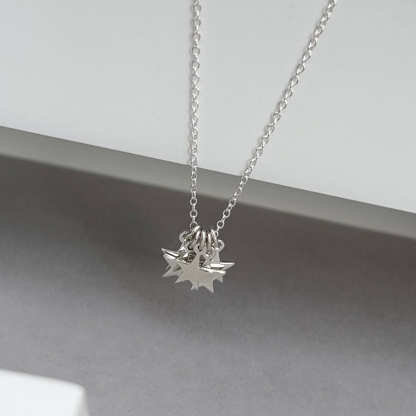 Sterling silver tiny star charm pendants on a trace chain