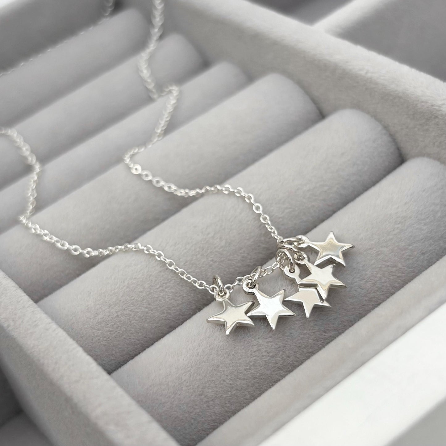 Sterling silver tiny star charm pendants on a trace chain