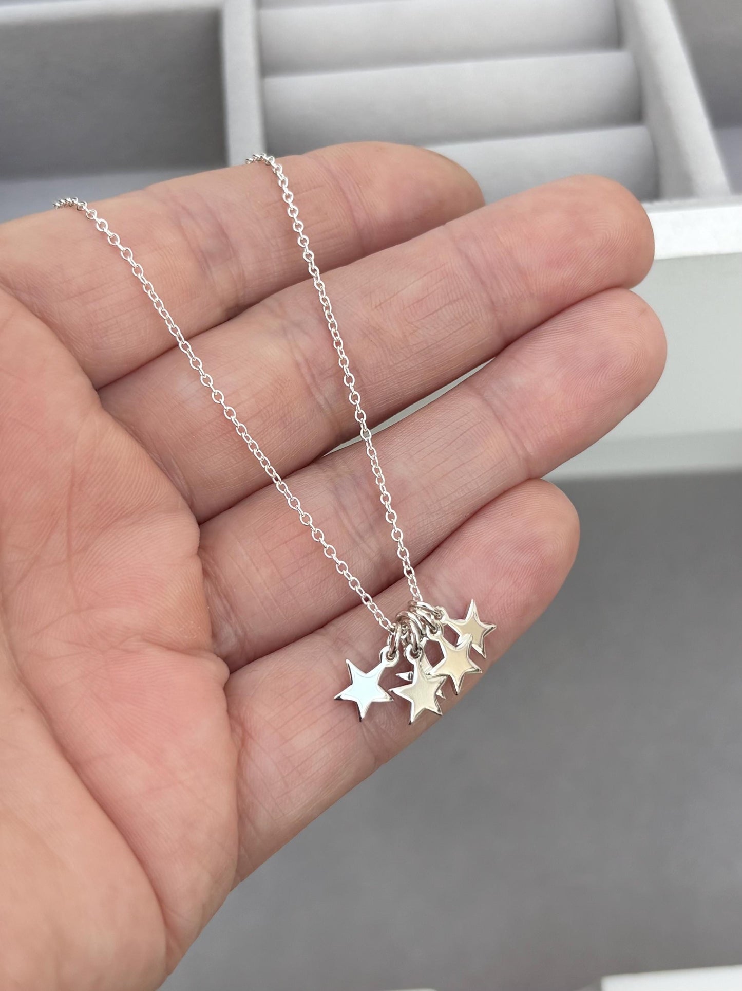 Sterling silver tiny star charm pendants on a trace chain