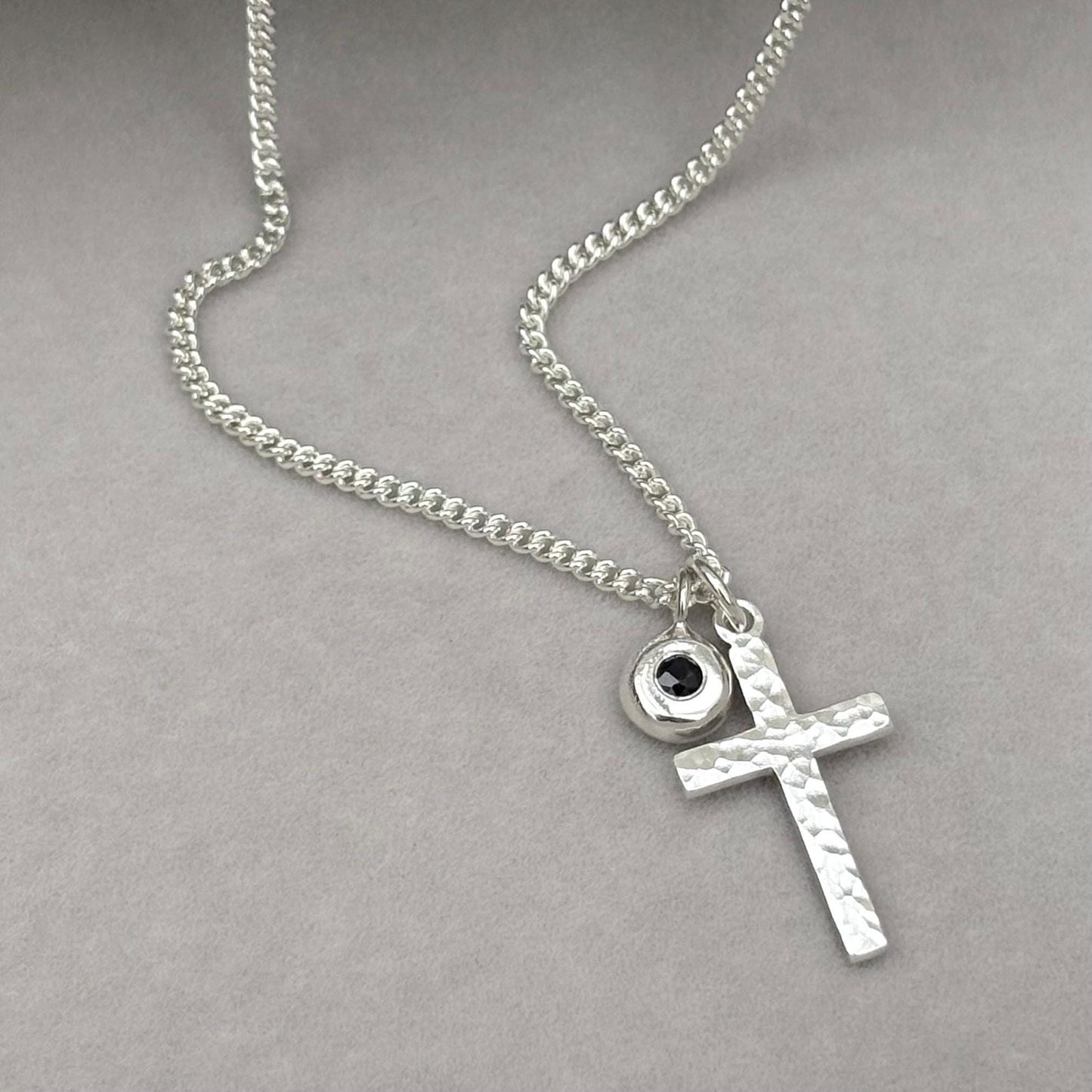 Oxidised or polished small size solid silver hammered cross pendant and black sapphire nugget charm on a curb chain