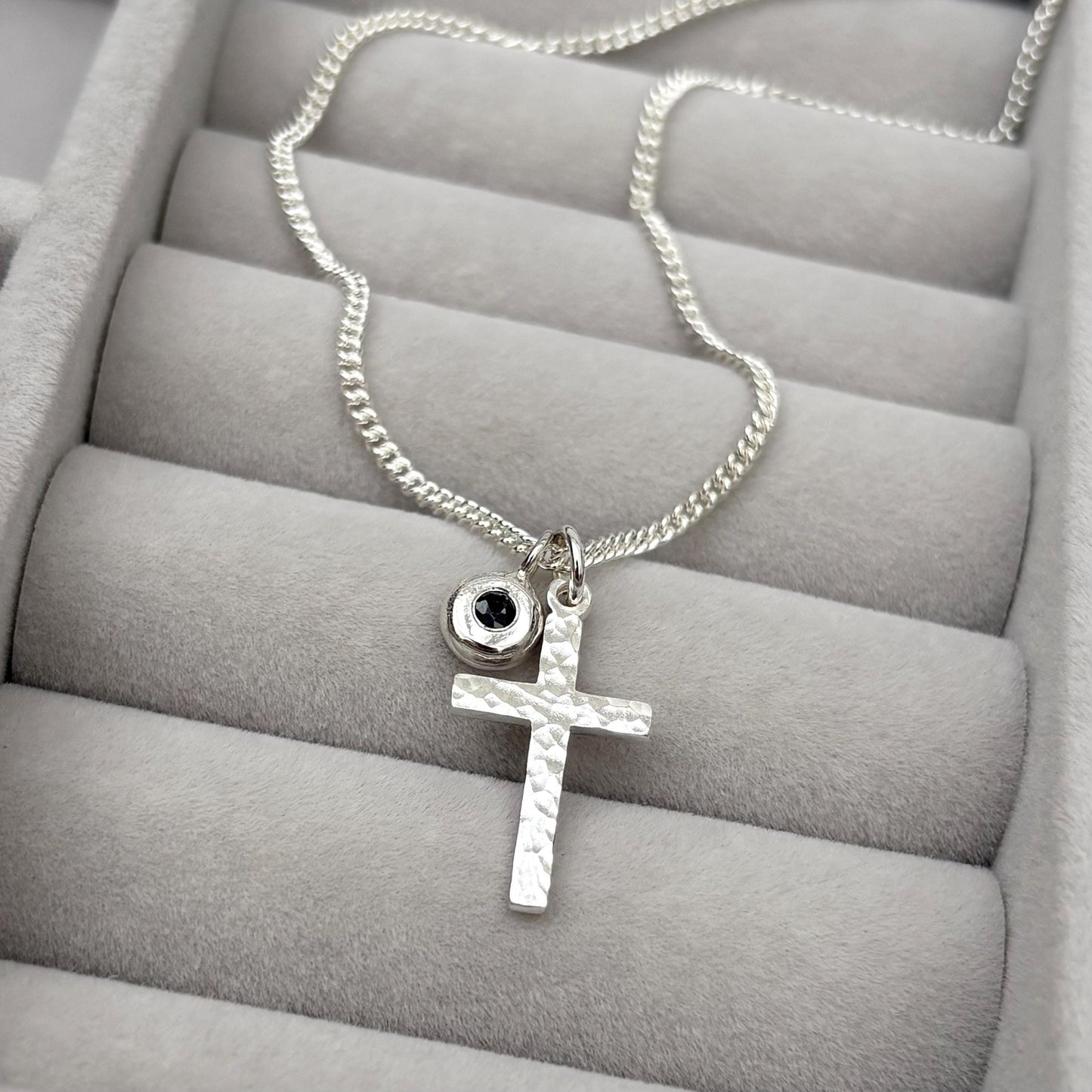 Oxidised or polished small size solid silver hammered cross pendant and black sapphire nugget charm on a curb chain