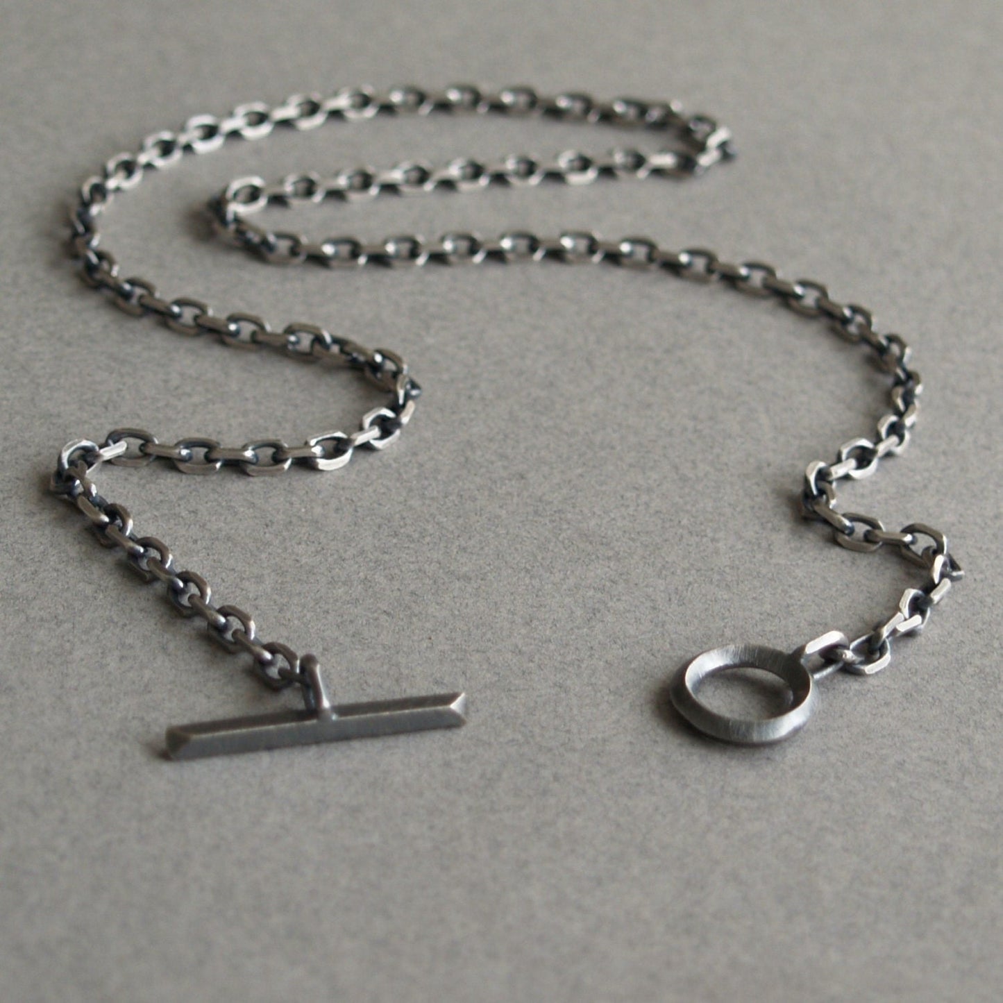 Oxidised or polished solid silver 4.2mm wide diamond cut trace chain with a unique T-bar design