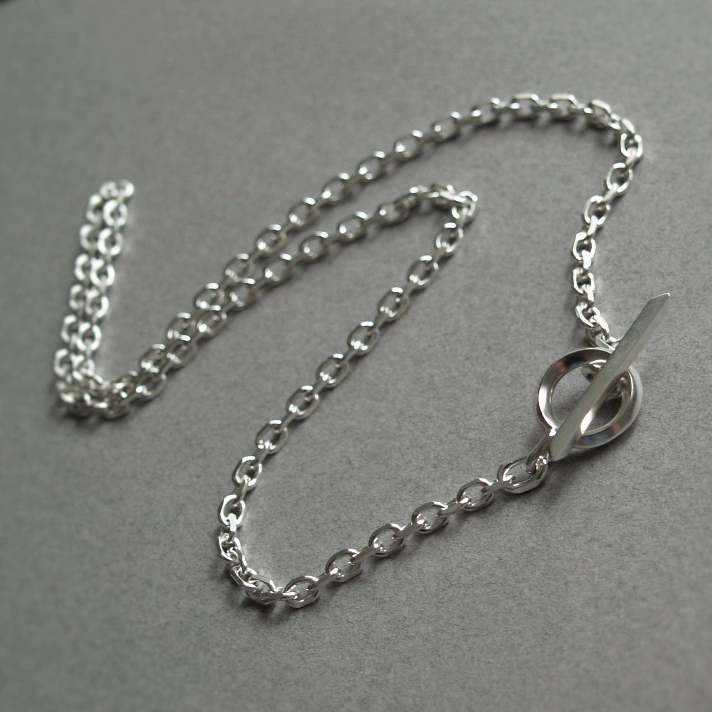 Oxidised or polished solid silver 4.2mm wide diamond cut trace chain with a unique T-bar design