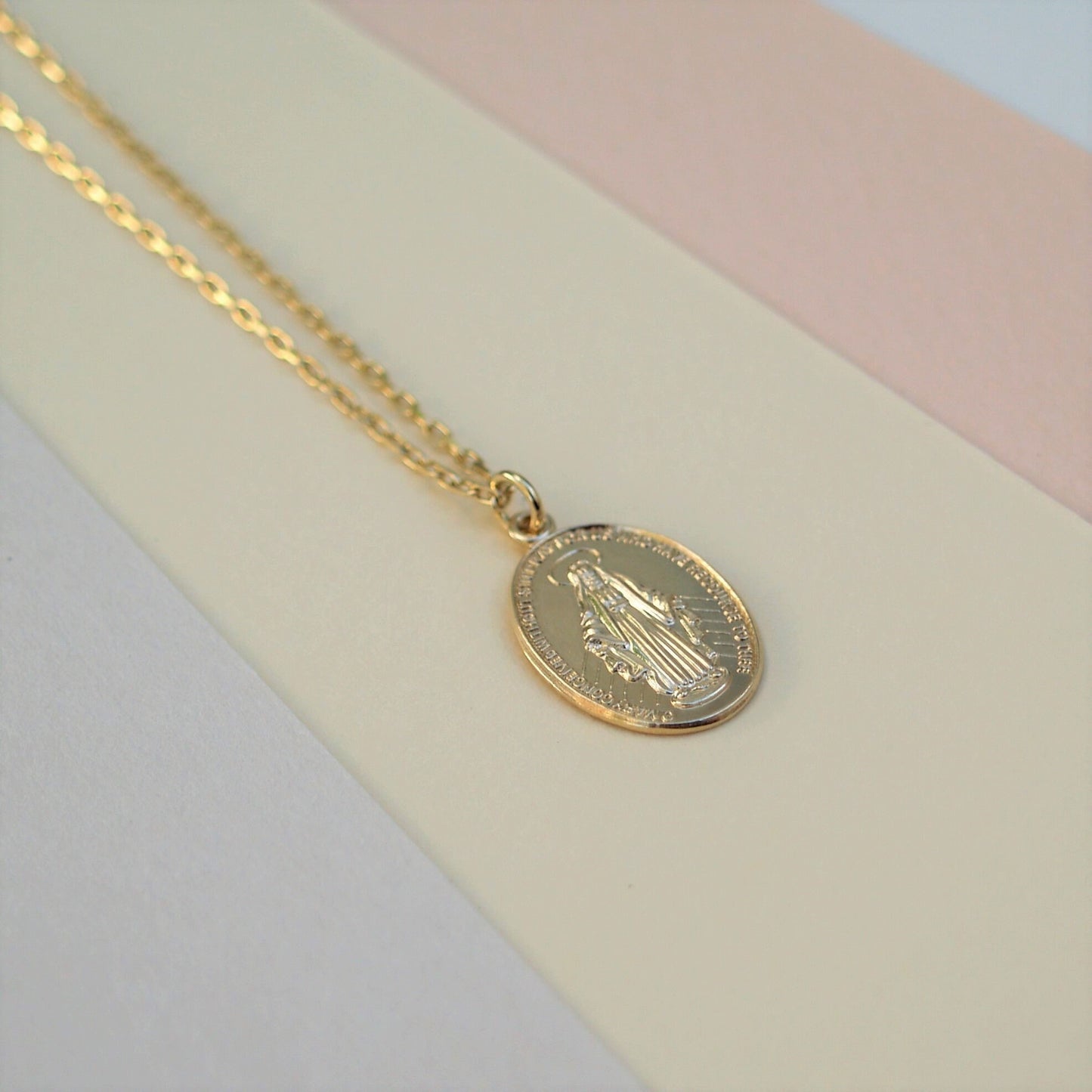 9ct solid yellow gold small size Miraculous Mary oval medal pendant on a 1.1mm wide diamond cut trace chain