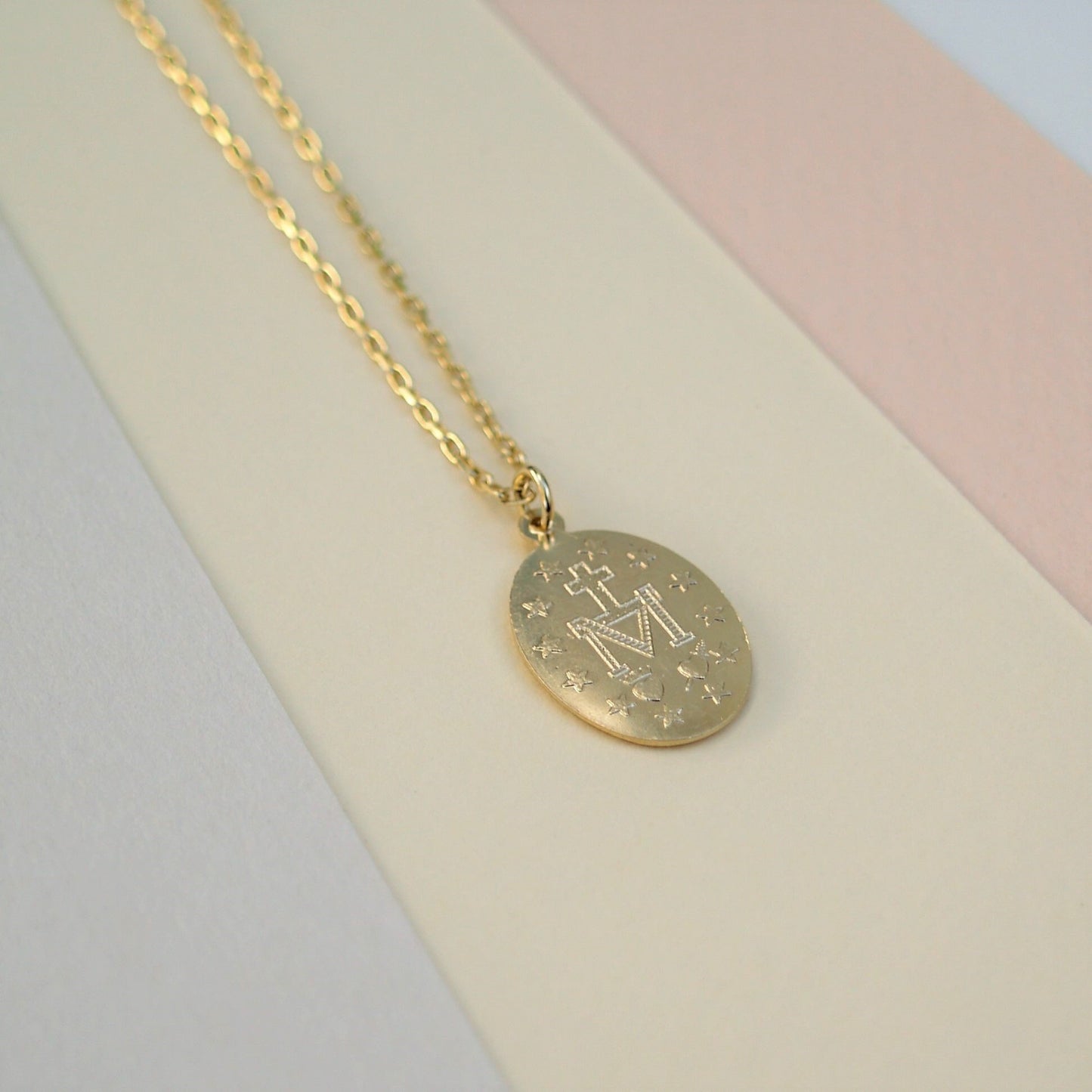 9ct solid yellow gold small size Miraculous Mary oval medal pendant on a 1.1mm wide diamond cut trace chain