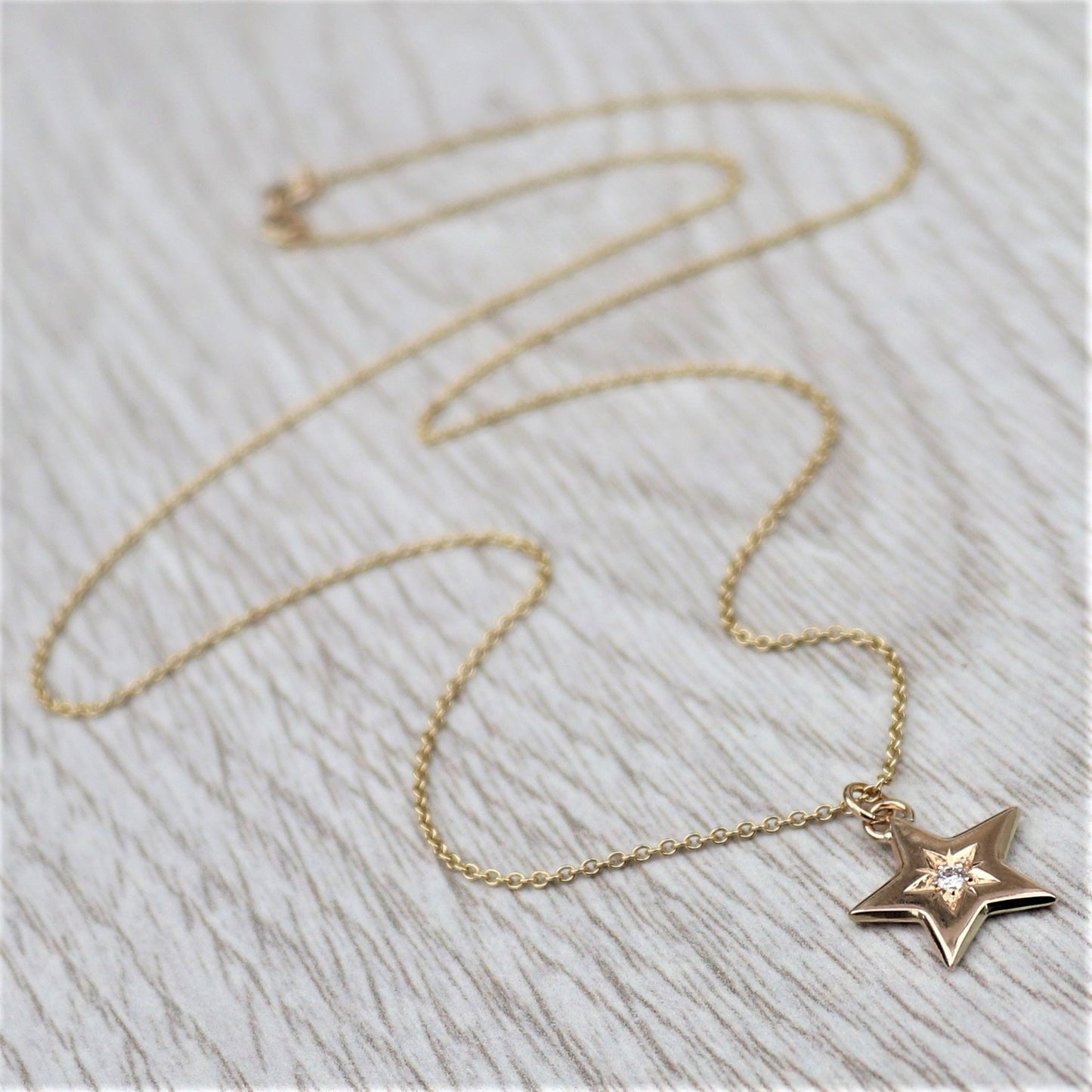 9ct solid yellow gold engraved diamond star pendant on a 1.2mm wide trace chain