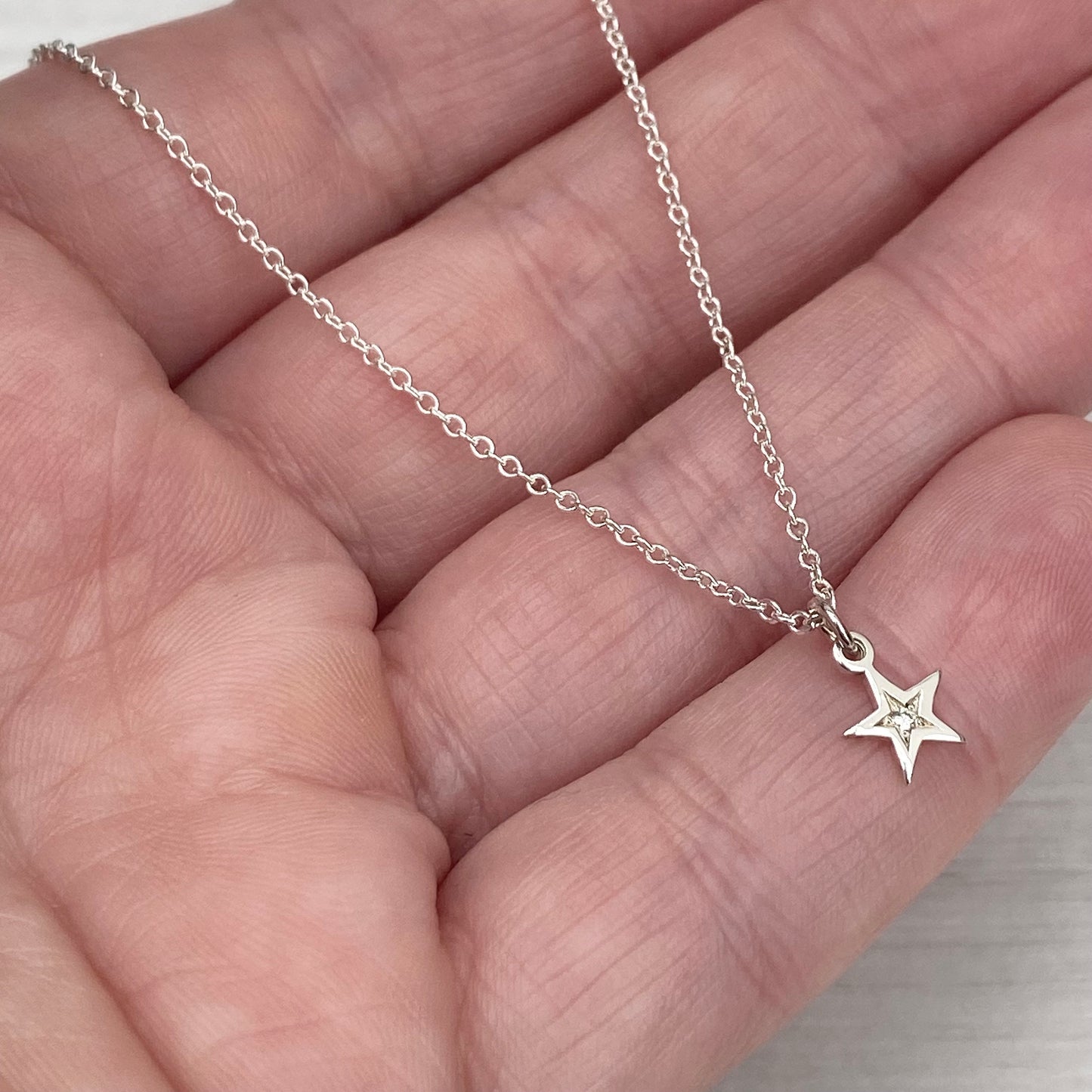 Sterling silver star engraved diamond tiny star charm pendant on a 1.2mm wide trace chain